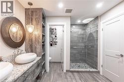 Bathroom with a shower stall, visible vents, a sink, and ceramic tile finished floors - 