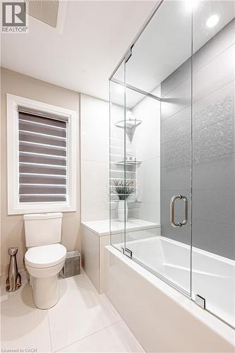 Full bathroom featuring tile patterned flooring, toilet, combined bath / shower with glass door, and visible vents - 477 Blair Creek Drive, Kitchener, ON - Indoor Photo Showing Bathroom