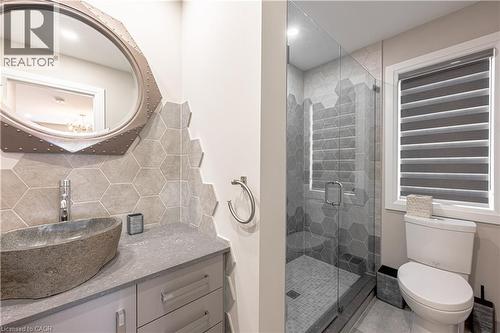 Bathroom with toilet, vanity, a shower stall, and decorative backsplash - 477 Blair Creek Drive, Kitchener, ON - Indoor Photo Showing Bathroom