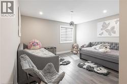 Bedroom featuring wood finished floors, baseboards, and recessed lighting - 