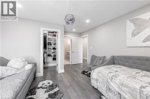 Bedroom featuring a closet, baseboards, a walk in closet, and wood finished floors - 477 Blair Creek Drive, Kitchener, ON - Indoor Photo Showing Bedroom