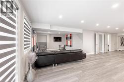 Living room featuring recessed lighting, baseboards, and wood finished floors - 