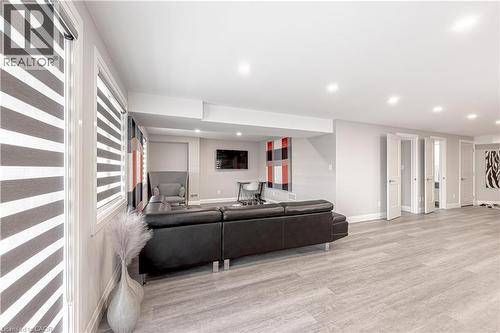 Living room featuring recessed lighting, baseboards, and wood finished floors - 477 Blair Creek Drive, Kitchener, ON - Indoor