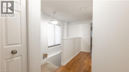 Hall with baseboards, an upstairs landing, and wood finished floors - 85 Bankside Drive Unit# E34, Kitchener, ON - Indoor Photo Showing Other Room