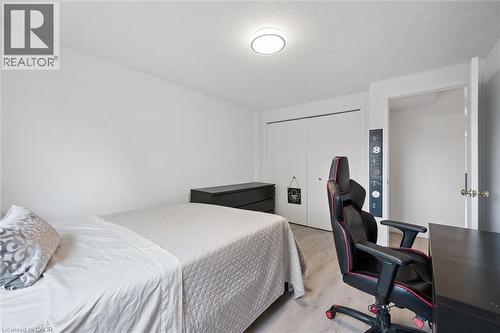 Bedroom featuring light wood-finish flooring, white painted walls, and a ceiling-mounted flush light fixture - 11 Patton Drive, Cambridge, ON - Indoor Photo Showing Bedroom