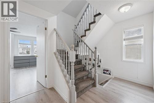 Carpeted staircase with painted wood balusters and handrail - 11 Patton Drive, Cambridge, ON - Indoor Photo Showing Other Room