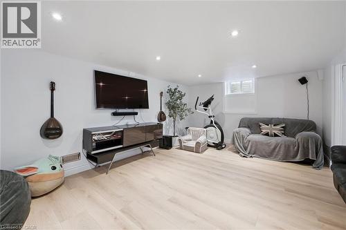Brightly lit room featuring light wood-finish flooring, recessed ceiling lighting, and a window with white louvered blinds - 11 Patton Drive, Cambridge, ON - Indoor