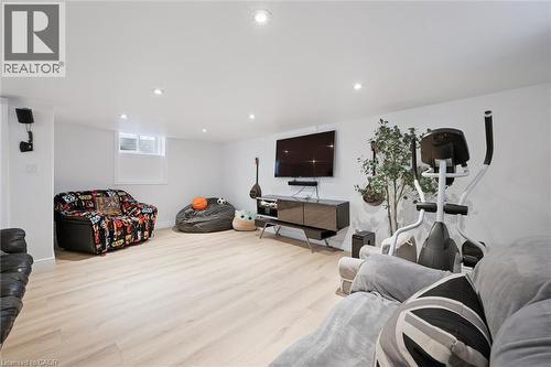 Spacious room featuring light wood-finish flooring, recessed lighting, white walls, and a window - 11 Patton Drive, Cambridge, ON - Indoor