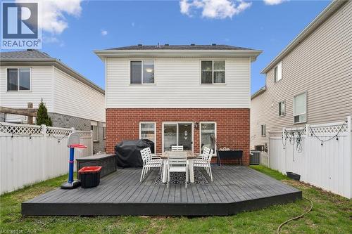 Spacious backyard featuring a multi-level deck, white vinyl privacy fencing, and a brick and siding exterior - 11 Patton Drive, Cambridge, ON - Outdoor With Deck Patio Veranda With Exterior