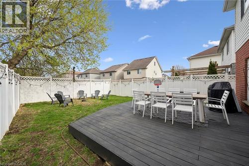 Expansive backyard featuring a dark composite deck, manicured lawn, and white privacy fencing - 11 Patton Drive, Cambridge, ON - Outdoor With Deck Patio Veranda With Exterior