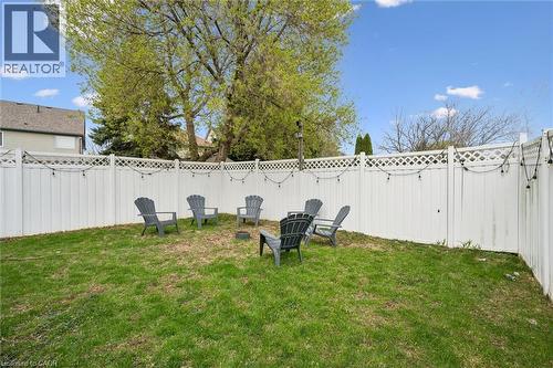 Fenced backyard featuring a manicured lawn and mature trees - 11 Patton Drive, Cambridge, ON - Outdoor