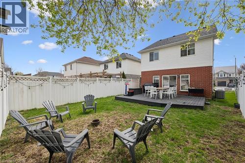 Expansive backyard featuring a white privacy fence, a multi-level deck with dark composite decking, and a brick and siding exterior - 11 Patton Drive, Cambridge, ON - Outdoor With Deck Patio Veranda