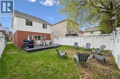 Spacious backyard featuring a composite deck, a white privacy fence, and a mature tree providing shade - 11 Patton Drive, Cambridge, ON - Outdoor With Deck Patio Veranda With Exterior