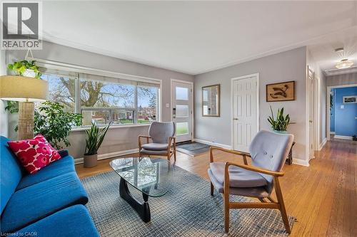 Living area featuring hardwood flooring, a large picture window, light gray wall paint, white baseboards, and a white ceiling - 154 Oriole Street, Waterloo, ON - Indoor Photo Showing Living Room