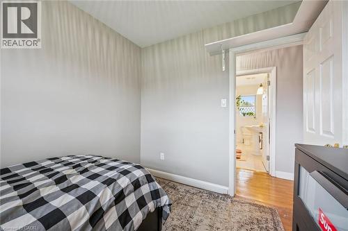 Light gray wall paint, hardwood flooring, and a white interior door - 154 Oriole Street, Waterloo, ON - Indoor Photo Showing Bedroom