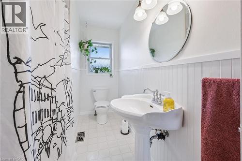 Bathroom featuring a pedestal sink, oval mirror, and three-light vanity fixture - 154 Oriole Street, Waterloo, ON - Indoor Photo Showing Bathroom