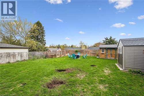 Expansive grassy yard with two storage sheds, a wood fence - 154 Oriole Street, Waterloo, ON - Outdoor