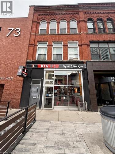 Brick facade building featuring arched windows on the upper levels - 85 King Street W, Kitchener, ON 
