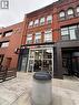 Red brick commercial facade with arched windows and a storefront entrance - 85 King Street W, Kitchener, ON 