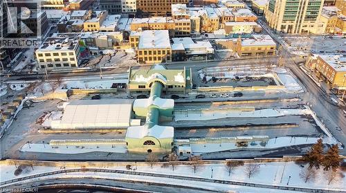 Central building featuring arched windows and a distinctive green roof - 85 King Street W, Kitchener, ON 