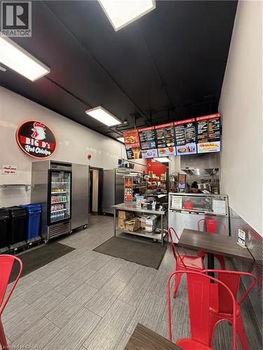 Commercial space featuring a service counter, overhead menu boards, and recessed lighting - 85 King Street W, Kitchener, ON 