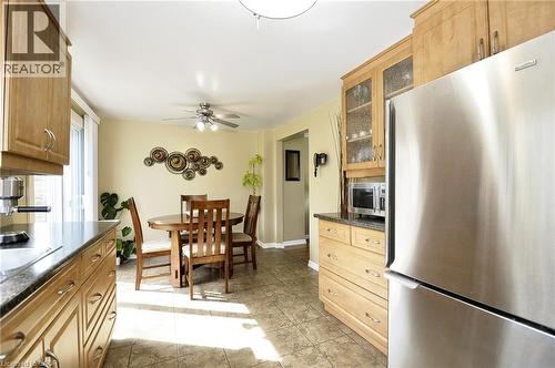 Contemporary kitchen featuring wood cabinetry, stainless steel appliances, and tiled flooring - 114 Bakersfield Drive, Cambridge, ON - Indoor