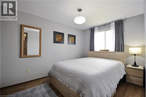 Neutral-toned bedroom featuring wood-finish flooring - 114 Bakersfield Drive, Cambridge, ON - Indoor Photo Showing Bedroom