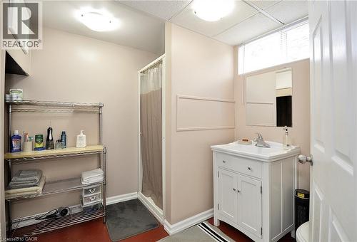 Bathroom featuring a white vanity with integrated sink, chrome faucet, and a wall-mounted mirror - 114 Bakersfield Drive, Cambridge, ON - Indoor