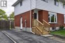 Brick and siding exterior featuring multiple windows and a front entrance with wooden stairs and railings - 114 Bakersfield Drive, Cambridge, ON  - Outdoor With Exterior 