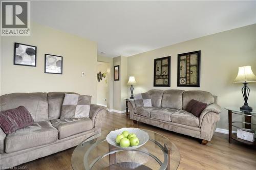 Living area with wood-finish flooring, neutral wall tones, and overhead lighting - 114 Bakersfield Drive, Cambridge, ON - Indoor Photo Showing Living Room