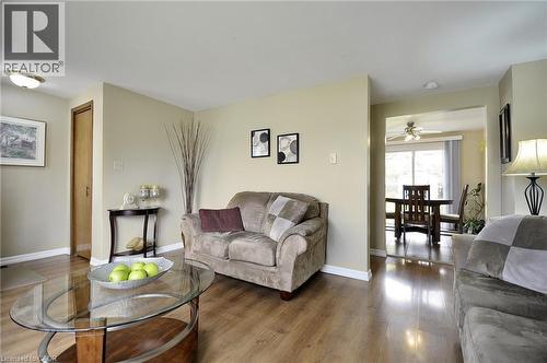 Living area featuring wood-finish flooring, light tan wall color, and white baseboards - 114 Bakersfield Drive, Cambridge, ON - Indoor Photo Showing Living Room