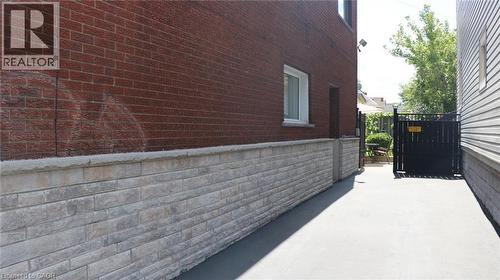 Side exterior with red brick and stone veneer siding - 1476 Barton Street E, Hamilton, ON - Outdoor With Exterior
