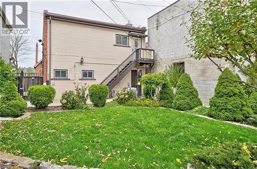 Grassed yard with established perimeter landscaping and mature trees - 1476 Barton Street E, Hamilton, ON - Outdoor