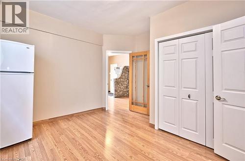 Wood-finish flooring throughout, complemented by light-toned wall paint - 1476 Barton Street E, Hamilton, ON - Indoor Photo Showing Other Room
