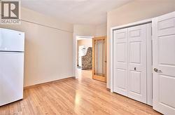 Wood-finish flooring throughout, complemented by light-toned wall paint - 