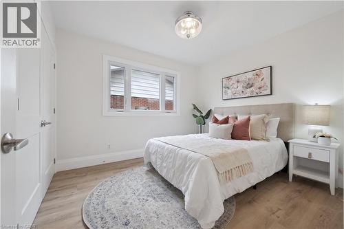 Light wood-finish flooring complements the neutral wall color - 111 Ruskview Road, Kitchener, ON - Indoor Photo Showing Bedroom