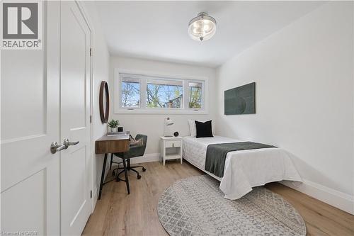 Bright room featuring light wood-finish flooring, white trim, and a window with a white frame - 111 Ruskview Road, Kitchener, ON - Indoor Photo Showing Bedroom