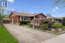 Brick facade residence featuring a brown shingle roof, white trim accents, and a covered front entry - 111 Ruskview Road, Kitchener, ON  - Outdoor 