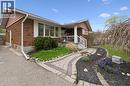 Brick exterior with white window shutters and a covered front porch featuring white railings - 111 Ruskview Road, Kitchener, ON  - Outdoor 