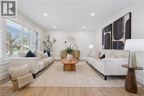 Bright living space featuring wood-finish flooring, recessed lighting, and white plantation shutters - 111 Ruskview Road, Kitchener, ON - Indoor Photo Showing Living Room