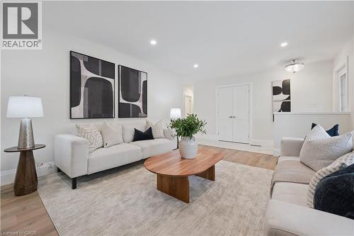 Spacious living area featuring light wood-finish flooring, recessed lighting, and crisp white walls - 111 Ruskview Road, Kitchener, ON - Indoor Photo Showing Living Room