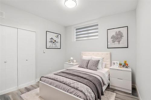 virtually staged bsmt suite - 624 Magnan Street, Winnipeg, MB - Indoor Photo Showing Bedroom