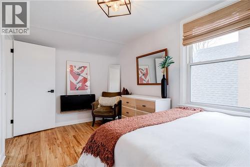 Bedroom with light wood-style floors, lofted ceiling, and a chandelier - 624 Burgess Avenue, Hamilton, ON - Indoor Photo Showing Bedroom