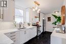 Kitchen with stainless steel electric range oven, white cabinetry, freestanding refrigerator, pendant lighting, and dishwasher - 624 Burgess Avenue, Hamilton, ON  - Indoor Photo Showing Kitchen 