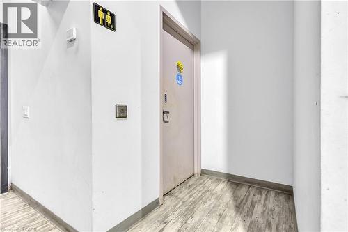 Entryway featuring light-colored wood-finish flooring, white painted walls, and a light-colored door with a security keypad - 545 Hespeler Road, Cambridge, ON 