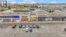 Retail plaza featuring multiple storefronts, a paved parking area, and rooftop HVAC units - 545 Hespeler Road, Cambridge, ON 