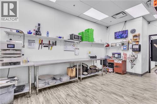 Commercial workspace featuring wood-finish flooring, white paneled walls, and recessed lighting - 545 Hespeler Road, Cambridge, ON 