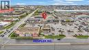 Commercial property featuring ample surface parking, multiple storefronts, and direct frontage on a paved road - 545 Hespeler Road, Cambridge, ON 