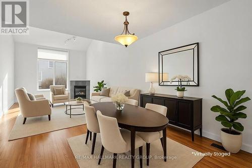Virtually Staged open dining and living area - 988 Lucille Way, Ottawa, ON - Indoor Photo Showing Other Room With Fireplace