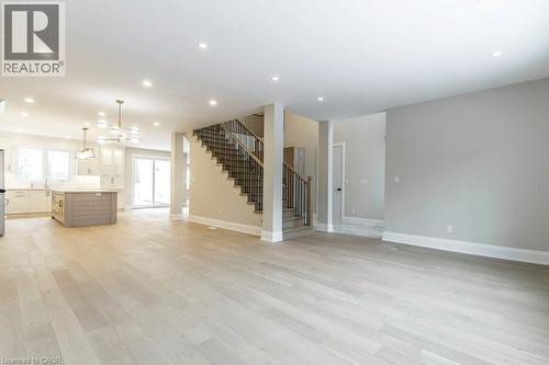 Unfurnished living room featuring hanging lights and light wood-style flooring - 1105 Main Street E, Cambridge, ON - Indoor